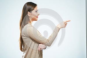 Smiling woman finger point. Isolated studio portrait