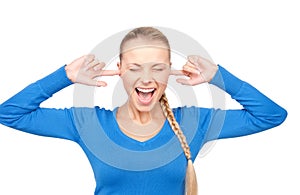 Smiling woman with fingers in ears