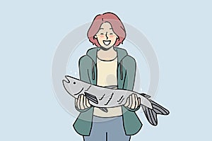 Smiling woman with fish haul in hands