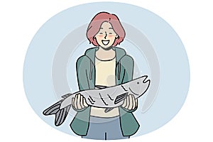 Smiling woman with fish haul in hands