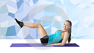 Smiling woman flexing abdominal muscles on mat