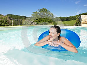 Smiling Woman Floating in Pool