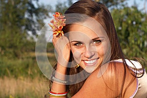 Smiling woman with flower in hair