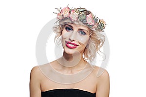 Smiling woman in flowers crown. Young model with short blonde curly hair and makeup isolated on white background