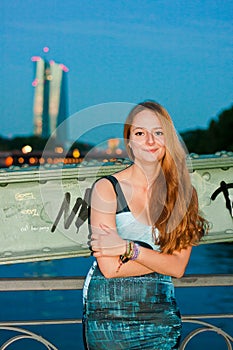 Smiling woman in front of urban night view