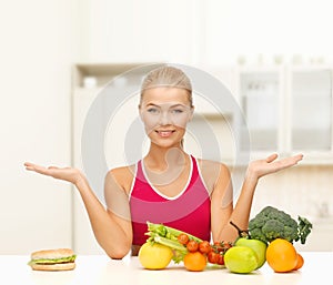 Smiling woman with fruits and hamburger