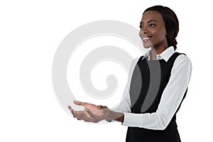 Smiling woman gesturing against white background