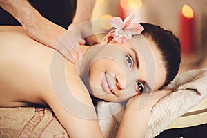 Smiling Woman Getting Back Massage in Health Spa