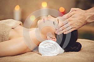 Smiling Woman Getting Massage in Health Spa