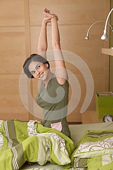 Smiling woman getting up stretching