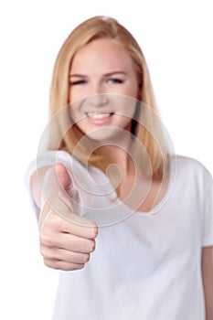 Smiling woman giving a thumbs up gesture