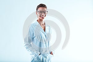 Smiling woman, glasses, hair up, in lab coat, career advanced