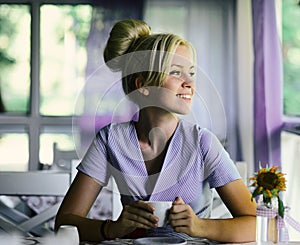 Smiling woman in a good mood with cup of coffee