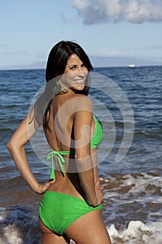 Smiling woman in a green bikini