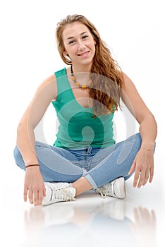 Smiling woman in green casual smart clothing, sitting crossed l