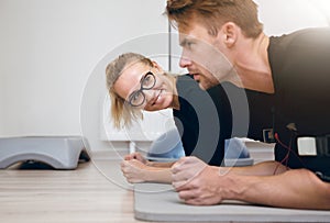 Smiling woman at the gym looking at the sportsman