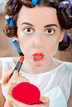 Smiling woman with hair curlers