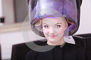 Smiling woman hair rollers curlers hairdryer hairdressing beauty salon