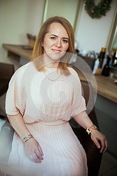 smiling woman hair salon client in dress in hair studio