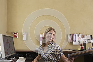 Smiling Woman Handing Off Documents