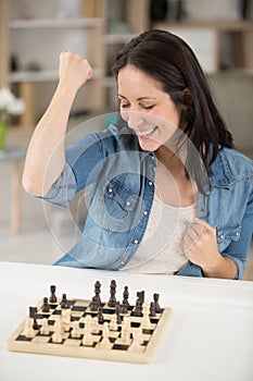 smiling woman happy about chess game