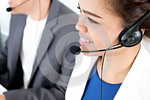 Smiling woman with headphone as an operator