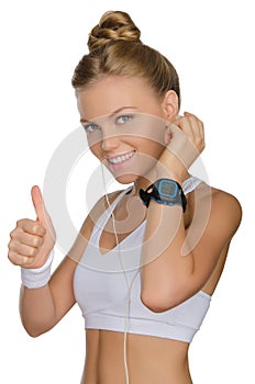 Smiling woman with headphones and clock