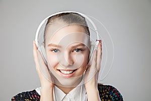 Smiling woman with headphones listening music