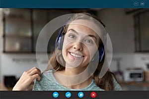 Smiling woman in headset speak on video call