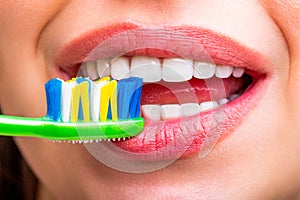 Smiling woman with healthy beautiful teeth holding a toothbrush. Portrait of a smiling cute woman holding toothbrush