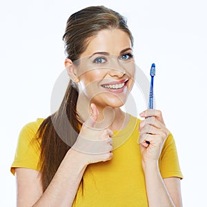 Smiling woman with healthy teeth holding toothy brush show thum