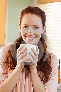 Smiling woman with her cup of coffee