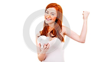 Smiling woman with her piggy bank
