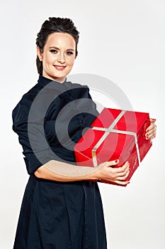 Smiling woman hold red gift box. Business woman in black dress