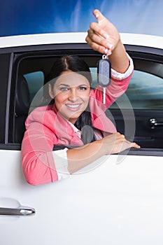 Smiling woman holding car key