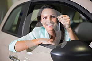 Smiling woman holding car key