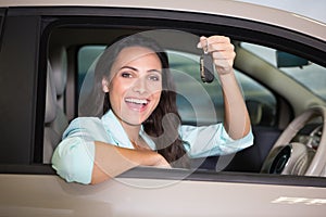 Smiling woman holding car key