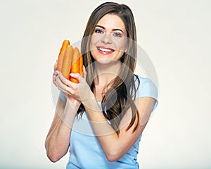 Smiling woman holding carrot. Isolated
