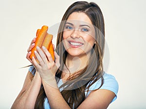 Smiling woman holding carrot. Isolated