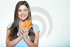 Smiling woman holding carrot. Isolated