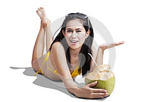 Smiling woman holding coconut drink