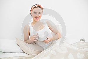 Smiling woman holding a cup of tea