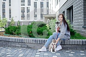 Smiling woman holding cute husky puppy