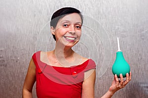 Smiling woman holding an enema.