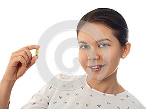 Smiling woman holding fish oil Omega-3 capsule
