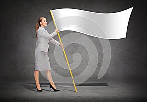 Smiling woman holding flagpole with white flag