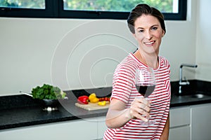 smiling woman holding a glass of wine