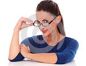 Smiling woman holding glasses while looking at you