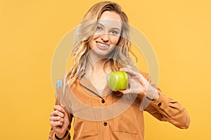 Smiling woman holding green apple and
