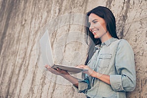 Smiling woman holding laptop and checking her email